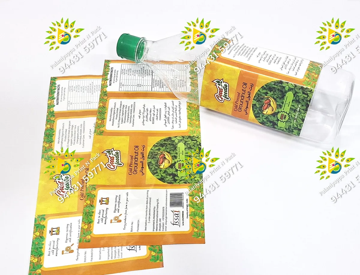 Groundnut oil label on a clear bottle beside matching loose labels.