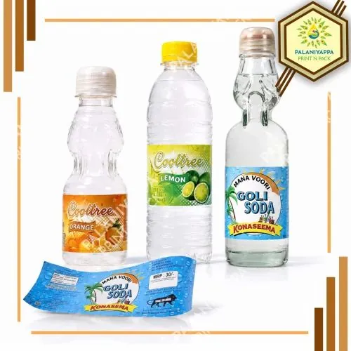 Three bottles with printed beverage labels and a flat soda label