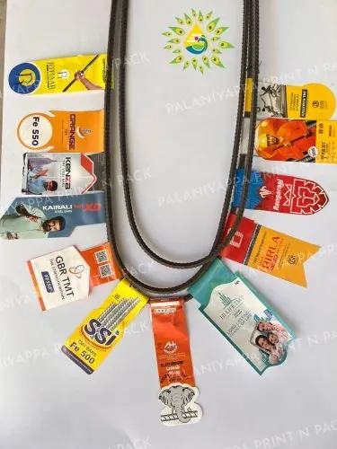 Printed tags fanned around a bent steel bar, on white