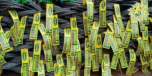 Rows of yellow-green tags hanging from bundled steel bars