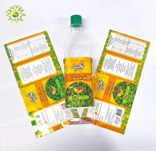 A labelled edible oil bottle between two printed label sheets