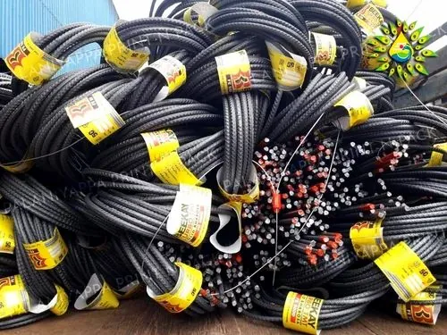 Yellow stick-on tags wrapped around coils of steel bars, the cut bar ends painted red