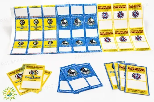 An uncut sheet of printed fish net labels above cut yellow and blue labels