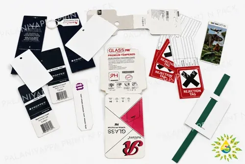 Assorted printed hang tags, some with barcodes and one on a green ribbon