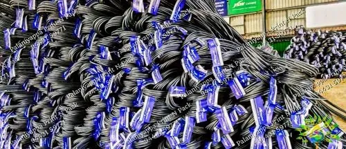 A heap of steel bar coils with blue tags, in a yard