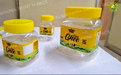 Three ghee jars with printed labels and yellow lids