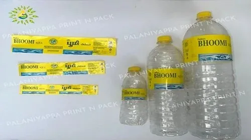 Printed water bottle label strips beside three labelled bottles of different sizes
